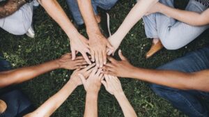 Several hands overlap