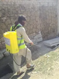 man spraying street