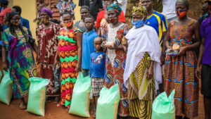 A local community in Sierra Leone gather to receive essential food and hygiene items amid the Covid-19 pandemic