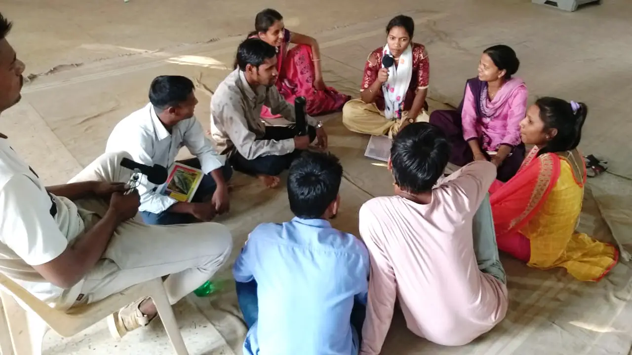 Adivasi community gather together and discuss local issues, creating content for the speaker boxes.