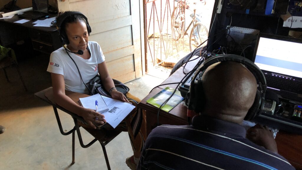 Women being interviewed on radio next to open door