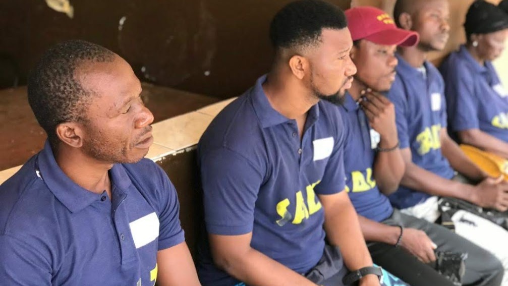 Men in SALT T shirts sitting in a row