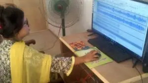 Woman editting audio on a computer