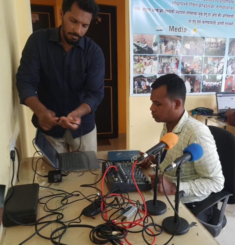 Man demonstrating audio equipment to another man