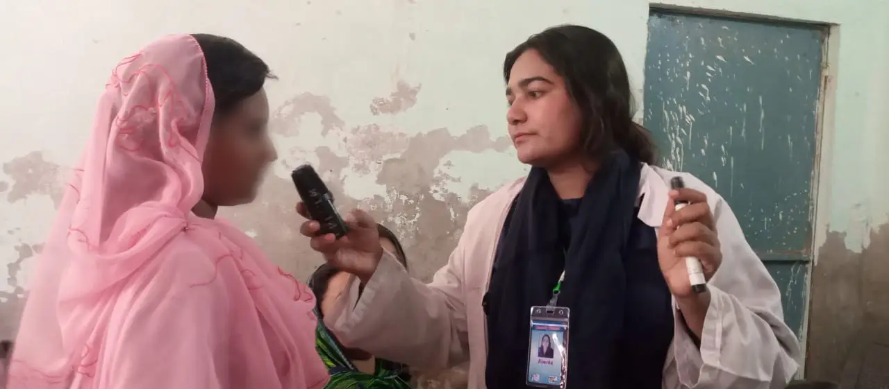 woman health worker interviewing another woman