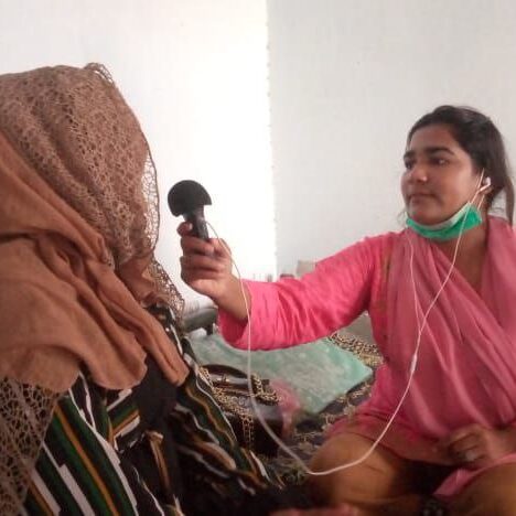 a woman interviewing a woman in headscarf