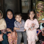 Pakistani children sitting with their mother