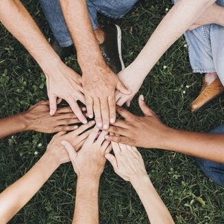 Several hands overlap